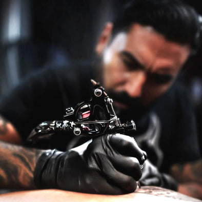 Tattoo Artist using gorilla gloves